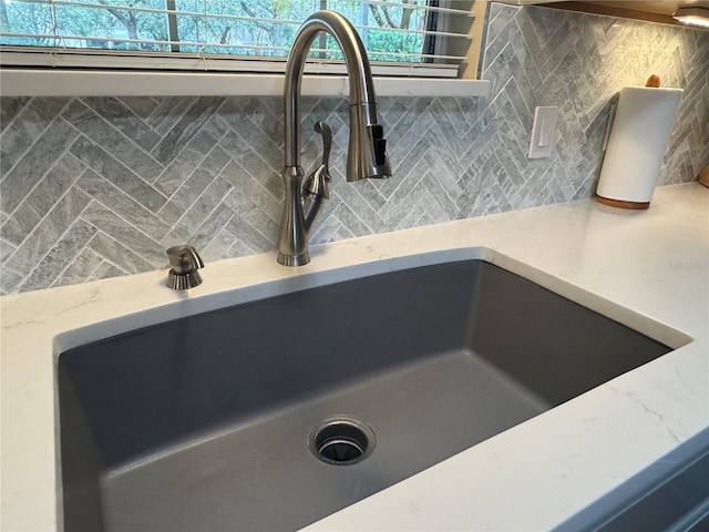 details featuring backsplash and sink