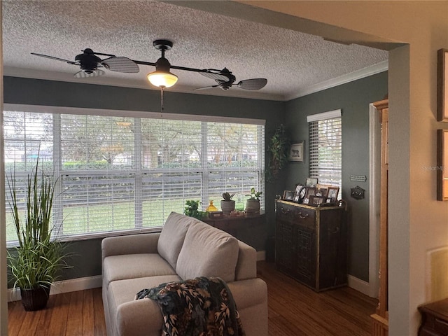 living room featuring ceiling fan, wood-type flooring, and a wealth of natural light