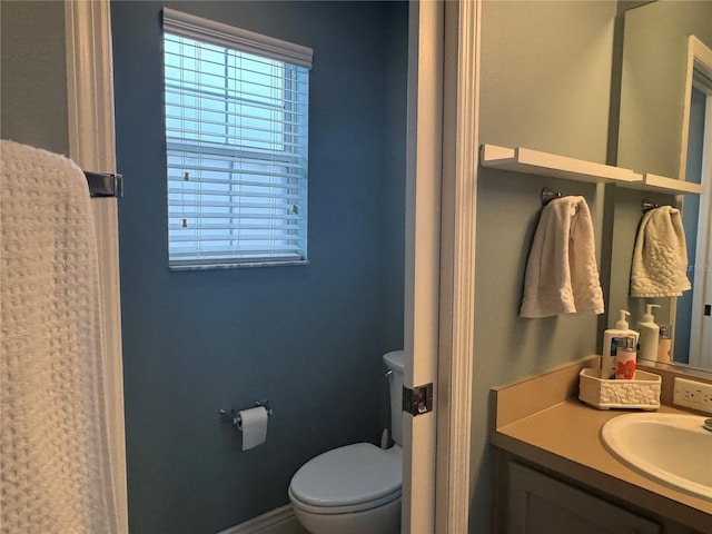 bathroom with toilet and vanity