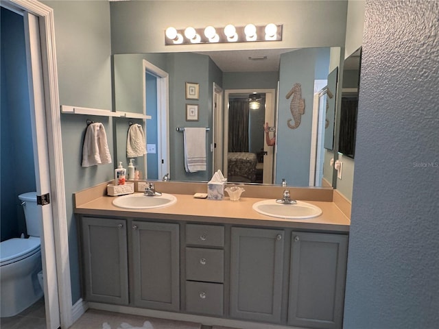 bathroom featuring toilet and vanity