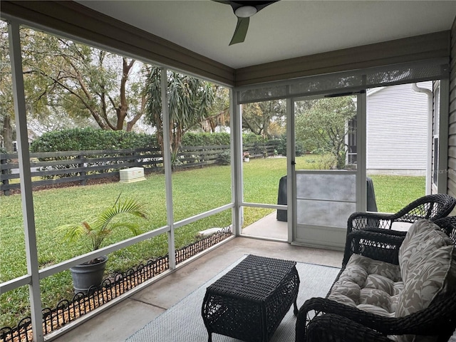 sunroom / solarium featuring ceiling fan and a healthy amount of sunlight