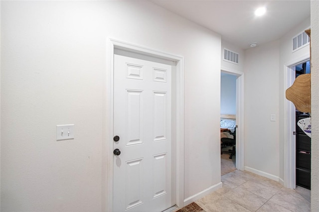 hallway featuring light tile patterned floors