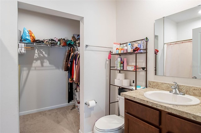 bathroom featuring a shower with curtain, vanity, and toilet