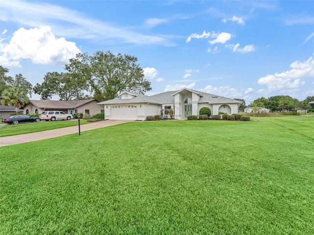 ranch-style house featuring a garage and a front yard