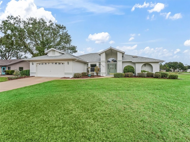 ranch-style house with a garage and a front yard