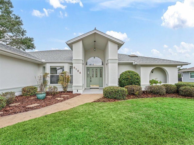 doorway to property featuring a lawn