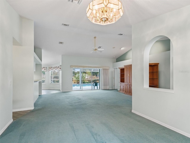 unfurnished living room with carpet floors, ceiling fan with notable chandelier, and high vaulted ceiling