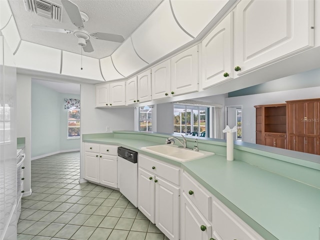 kitchen with ceiling fan, sink, dishwasher, white cabinetry, and light tile patterned flooring