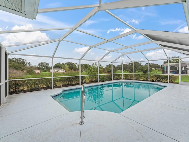 view of pool with a patio and a lanai