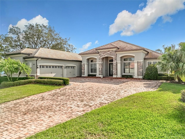 mediterranean / spanish-style house with a front lawn and a garage