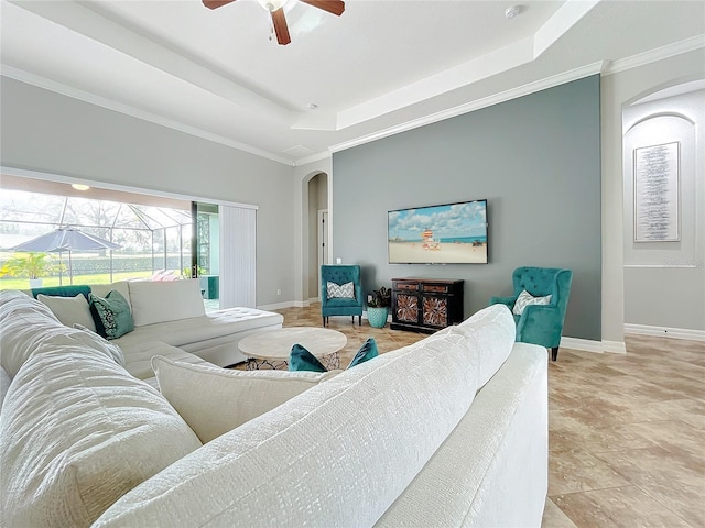 living room featuring a tray ceiling and ceiling fan