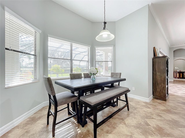 dining space featuring crown molding