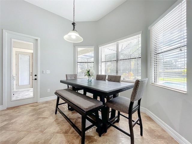 dining space featuring light tile patterned flooring