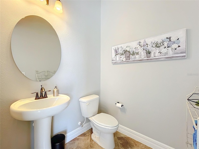 bathroom with tile patterned flooring and toilet