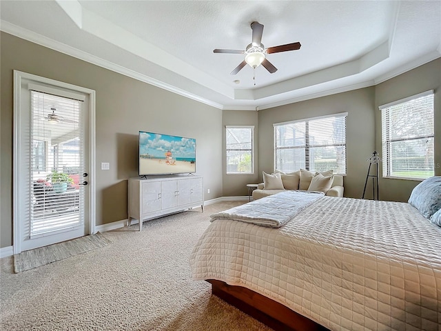 carpeted bedroom with access to outside, a raised ceiling, ceiling fan, and ornamental molding