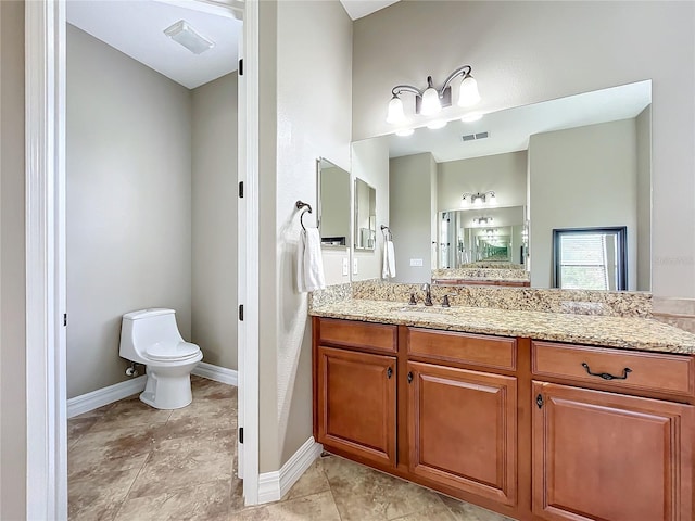 bathroom featuring vanity and toilet