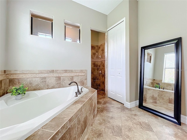 bathroom with tiled bath