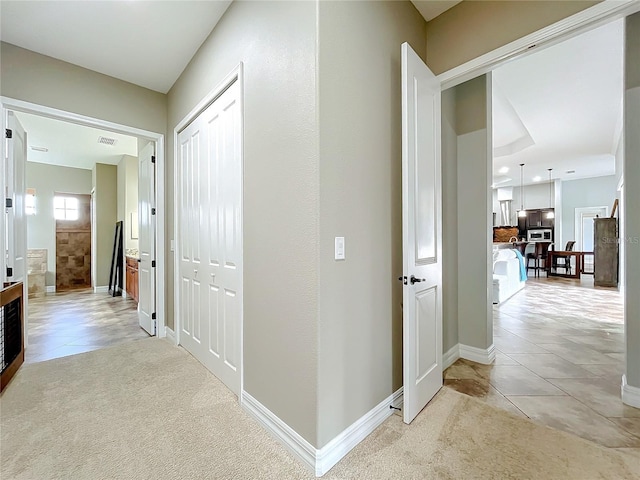 hall with light tile patterned flooring