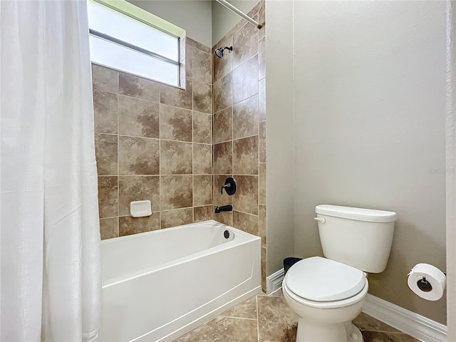 bathroom with tile patterned flooring, toilet, and shower / bathtub combination with curtain