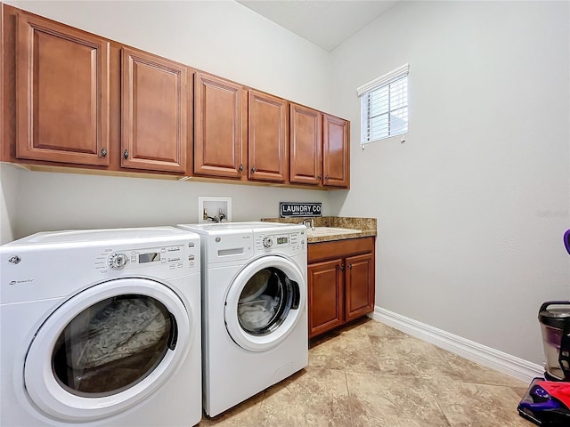 laundry room featuring cabinets and separate washer and dryer