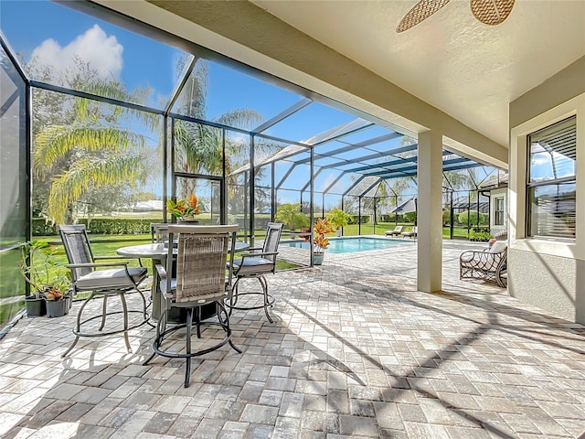 view of patio / terrace featuring a lanai and ceiling fan