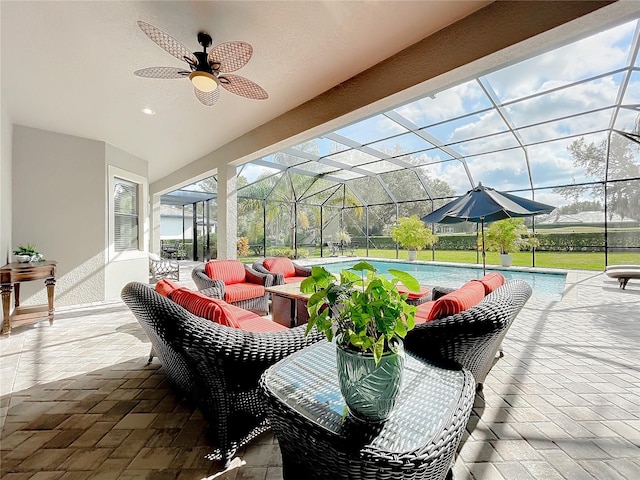 view of patio / terrace with glass enclosure, ceiling fan, and outdoor lounge area