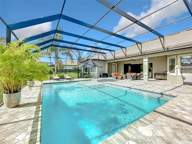 view of pool featuring an outdoor living space, ceiling fan, a lanai, and a patio