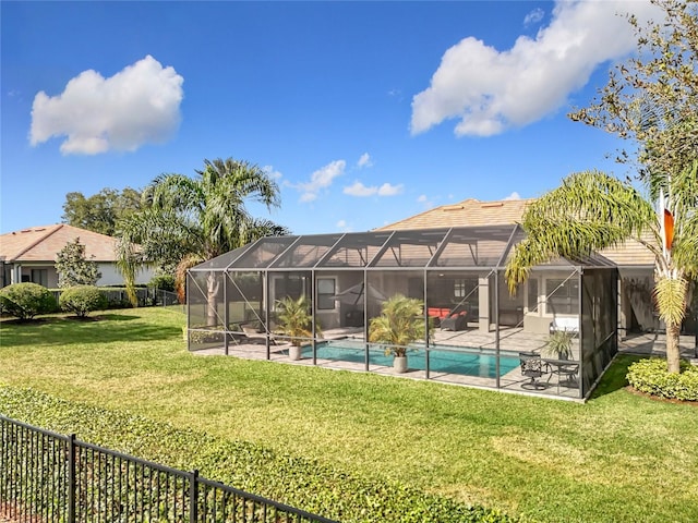 view of swimming pool with a lanai, a lawn, and a patio