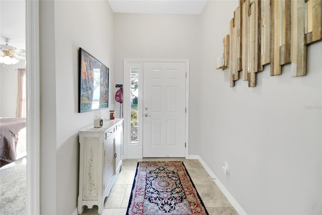 entryway with ceiling fan and light tile patterned floors