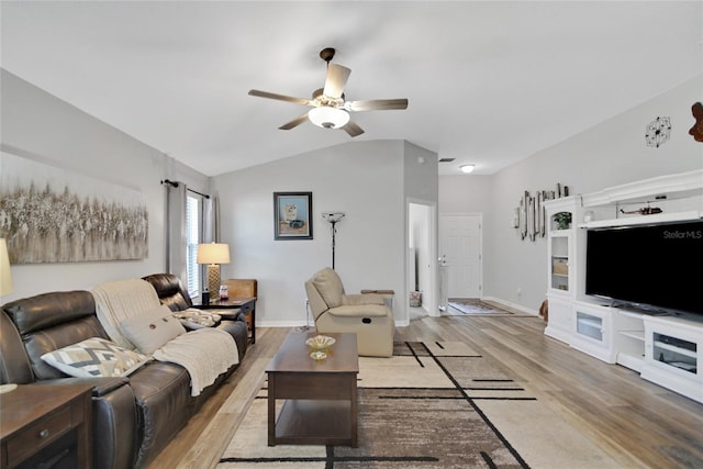 living room featuring light hardwood / wood-style floors, vaulted ceiling, and ceiling fan