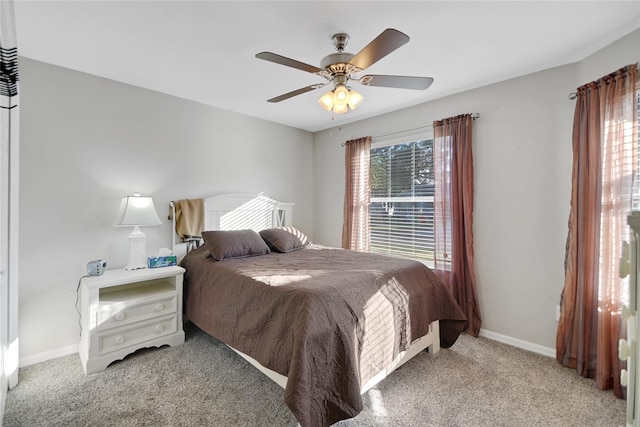 bedroom featuring ceiling fan and light carpet