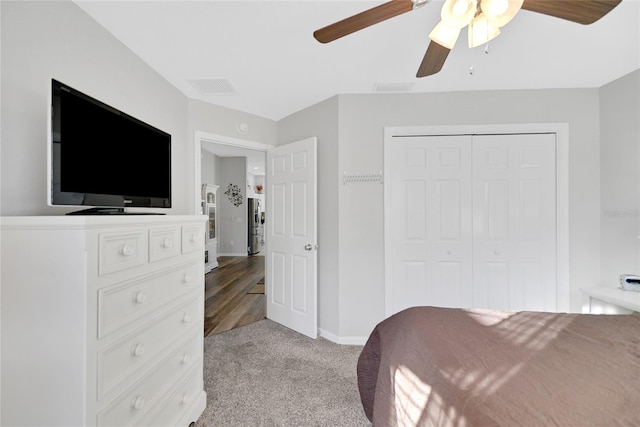 carpeted bedroom featuring ceiling fan and a closet