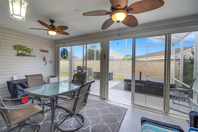 sunroom featuring ceiling fan and a healthy amount of sunlight