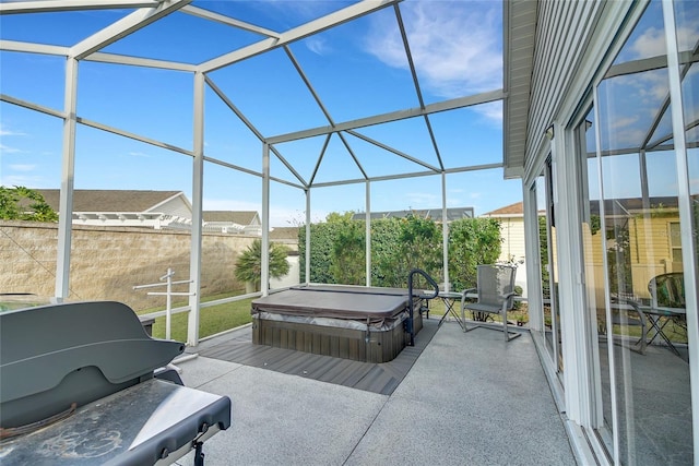 view of patio with a lanai, grilling area, and a covered hot tub