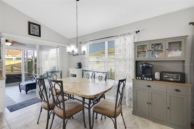 tiled dining room featuring ceiling fan, a wealth of natural light, and vaulted ceiling