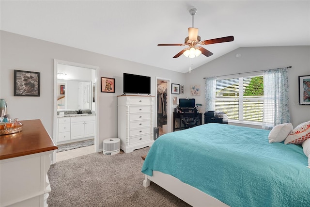 carpeted bedroom with lofted ceiling, a walk in closet, ceiling fan, connected bathroom, and a closet