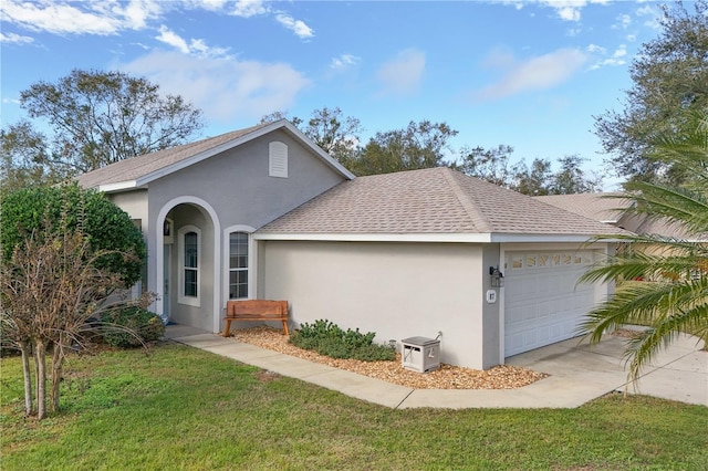 view of front of property featuring a garage and a front lawn