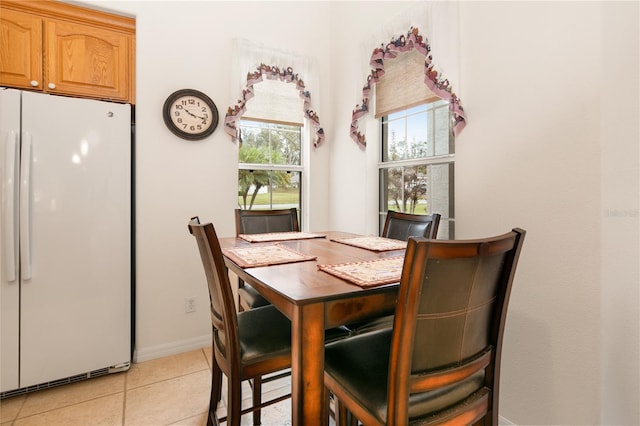 tiled dining space with a healthy amount of sunlight