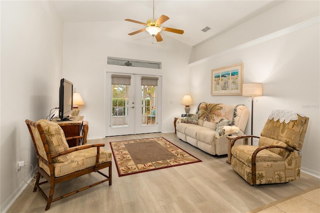 living room featuring ceiling fan, lofted ceiling, light hardwood / wood-style flooring, and french doors