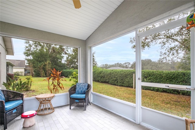 sunroom / solarium featuring ceiling fan and lofted ceiling