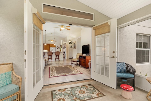 interior space featuring french doors, ceiling fan, and lofted ceiling