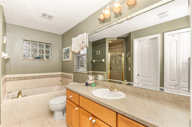 full bathroom with vanity, tile patterned floors, separate shower and tub, toilet, and a textured ceiling