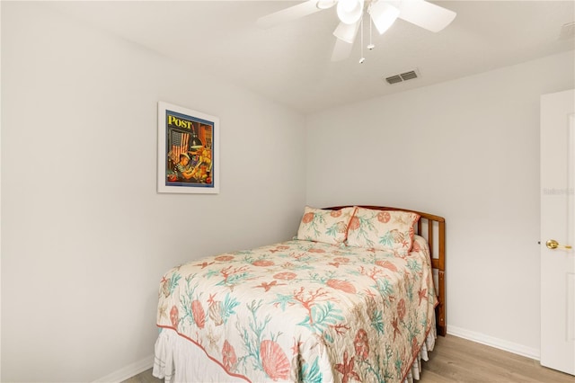 bedroom with ceiling fan and light wood-type flooring