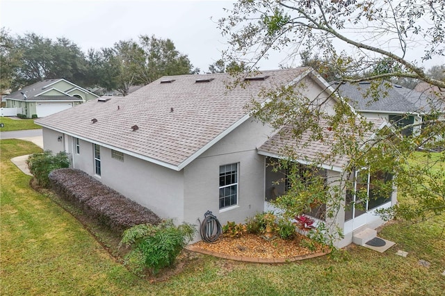 back of house featuring a sunroom and a yard