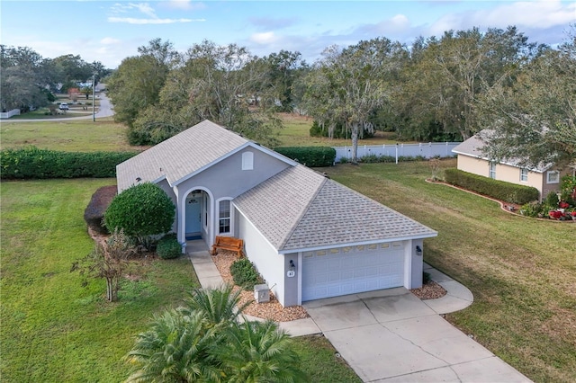 view of front of property featuring a front yard and a garage