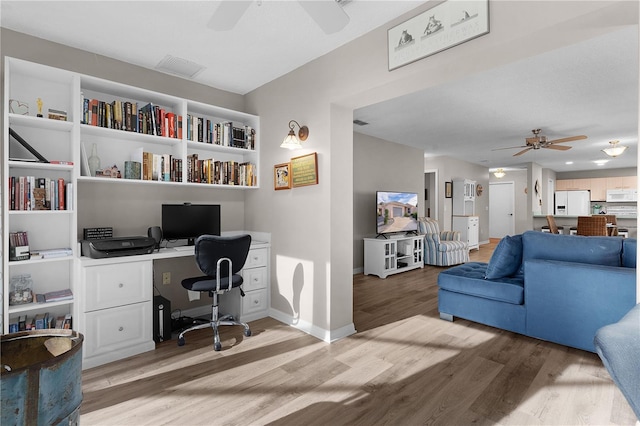 office space with hardwood / wood-style floors and ceiling fan