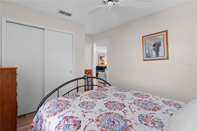 bedroom featuring a closet, ceiling fan, and light wood-type flooring