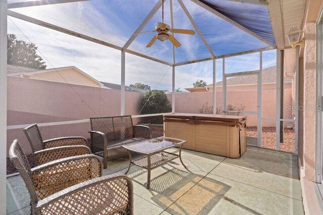 sunroom / solarium featuring ceiling fan