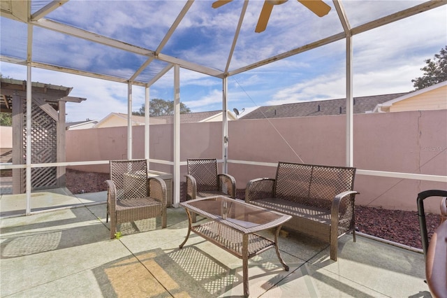 view of patio with an outdoor living space and a lanai