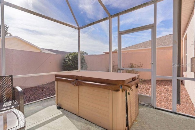 sunroom featuring a hot tub